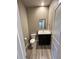 Clean powder room with a dark vanity, toilet, and modern mirror at 183 Mt Bierstadt St, Brighton, CO 80601