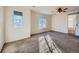 Main bedroom with large windows, carpeted floors, and a ceiling fan at 5224 Mt Arapaho Cir, Frederick, CO 80504