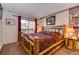 King-size bed in main bedroom with log bed frame at 405 Four Oclock Rd # 13A, Breckenridge, CO 80424