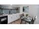 Small kitchen with white cabinets and a breakfast table at 1417 Monroe St, Denver, CO 80206