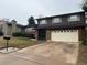 Two-story house exterior with attached garage and landscaping at 8632 E Layton Ave, Denver, CO 80237