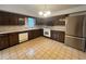 Kitchen with dark wood cabinets and modern appliances at 8632 E Layton Ave, Denver, CO 80237