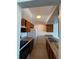 Galley-style kitchen with wood cabinets, white appliances, and laminate counters at 467 S Memphis Way # 17, Aurora, CO 80017