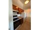 Kitchen features wood cabinets, a white refrigerator, and a black stove at 467 S Memphis Way # 17, Aurora, CO 80017