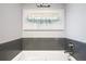 Bathroom with soaking tub and gray tile surround at 11785 W 66Th Pl # A, Arvada, CO 80004