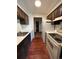 Galley kitchen with wood cabinets, stainless steel appliances, and hardwood floors at 364 S Ironton St # 419, Aurora, CO 80012