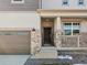 Front entrance with stone accents, a double door, and a small porch at 9129 Pitkin St, Commerce City, CO 80022