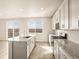 Modern kitchen with island, stainless steel appliances, and white cabinets at 9129 Pitkin St, Commerce City, CO 80022