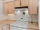 White stove and overhead lighting brighten this kitchen area at 4009 Wonderland Hill Ave, Boulder, CO 80304