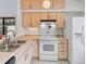 Kitchen features white appliances and light wood cabinets at 4009 Wonderland Hill Ave, Boulder, CO 80304