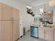 Modern kitchen with stainless steel dishwasher and light-toned wood cabinets at 4009 Wonderland Hill Ave, Boulder, CO 80304