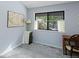 Cozy bedroom with grey carpet, a window, and a small wooden desk at 4009 Wonderland Hill Ave, Boulder, CO 80304