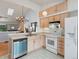 Bright kitchen with white appliances and light wood cabinets at 4009 Wonderland Hill Ave, Boulder, CO 80304