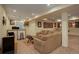 Open concept basement with sectional sofa, bar, and ping pong table at 5233 E 140Th Pl, Thornton, CO 80602