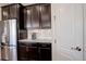 Kitchen with stainless steel refrigerator and dark wood cabinets at 5233 E 140Th Pl, Thornton, CO 80602