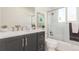 Modern bathroom with dark vanity, white toilet and shower/tub combo at 9120 Judson St, Westminster, CO 80031