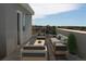 Private rooftop deck with outdoor furniture and city views at 6967 E Lowry Blvd, Denver, CO 80230