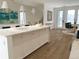 Bright kitchen boasts a large island with white cabinetry and marble countertops at 6967 E Lowry Blvd, Denver, CO 80230