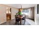 Bright dining room features a wood table with four chairs and a view of the kitchen at 29196 Little Big Horn Dr, Evergreen, CO 80439