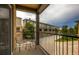 Small balcony with metal chairs and table, community view at 609 W Burgundy St # A, Highlands Ranch, CO 80129