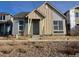 Craftsman style home with a two-car garage and a charming front porch at 2277 Serenidad St, Brighton, CO 80601