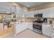 Spacious kitchen with white cabinetry, stainless steel appliances, and plenty of counter space at 7999 E Vassar Dr, Denver, CO 80231