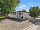 White single-wide manufactured home with covered porch at 8970 Decatur St, Denver, CO 80260