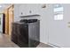 Stackable washer and dryer in a well-lit laundry room at 8970 Decatur St, Denver, CO 80260