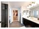 Modern bathroom with double vanity, a large mirror and walk-in shower at 25026 E Bayaud Pl, Aurora, CO 80018