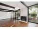 Bright living room with fireplace, large windows, and hardwood floors at 1495 S Elm St, Denver, CO 80222