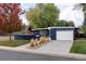 Mid-century modern home with blue exterior and landscaping at 1495 S Elm St, Denver, CO 80222