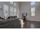 Bright living room with hardwood floors, large windows, and comfortable seating at 2599 S Jebel Way, Aurora, CO 80013