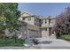 Two-story home with brick and siding exterior, showcasing its curb appeal at 2599 S Jebel Way, Aurora, CO 80013