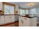 White kitchen with stainless steel appliances and granite island at 2599 S Jebel Way, Aurora, CO 80013