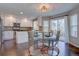 Modern kitchen featuring white cabinets, stainless steel appliances, and breakfast nook at 2599 S Jebel Way, Aurora, CO 80013