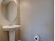 Small powder room with pedestal sink and oval mirror at 2599 S Jebel Way, Aurora, CO 80013