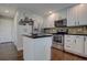 Updated kitchen with granite countertops, stainless steel appliances, and island at 2599 S Jebel Way, Aurora, CO 80013