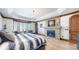 Main bedroom features a large bed, fireplace, and plenty of natural light at 7755 Moore Rd, Littleton, CO 80125