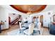 Open dining room with a round table, access to the staircase and views to the backyard at 7755 Moore Rd, Littleton, CO 80125