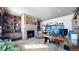 Home office with built-in shelves, fireplace, and large work desk at 7755 Moore Rd, Littleton, CO 80125