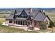 Luxury home with stone exterior, expansive patio, and mountain views at 7755 Moore Rd, Littleton, CO 80125