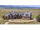 Luxury home with stone exterior, circular drive, and mountain views at 7755 Moore Rd, Littleton, CO 80125