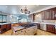 Bright kitchen boasts an island with copper countertop and high-end appliances at 7755 Moore Rd, Littleton, CO 80125