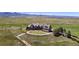 Luxury home with stone exterior, circular drive, and mountain views at 7755 Moore Rd, Littleton, CO 80125