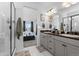 Bathroom with double vanity, shower and bedroom view at 17577 Drake St, Broomfield, CO 80023