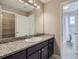 Bathroom with granite countertop, dark cabinets and a shower at 3423 Princeton Pl, Broomfield, CO 80023