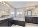 Large bathroom with granite countertop, soaking tub, and double sinks at 3423 Princeton Pl, Broomfield, CO 80023