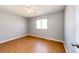 Well-lit bedroom featuring hardwood floors and a window at 241 Birch St, Bennett, CO 80102