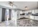 Kitchen with white cabinets, laminate flooring, and a door to outside at 241 Birch St, Bennett, CO 80102