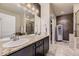 Double vanity bathroom with granite countertop and shower at 6655 S Shawnee St, Aurora, CO 80016